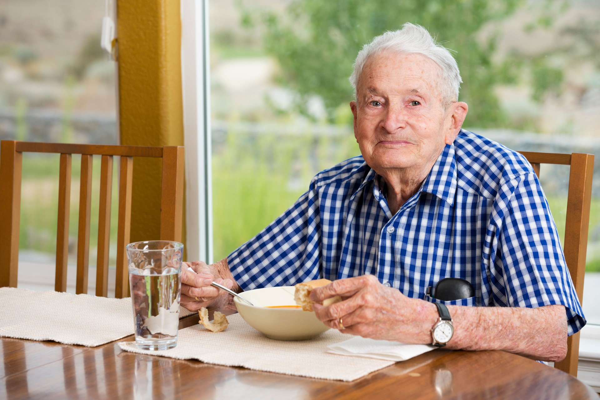 Senior man in his 90s eating lunch at home